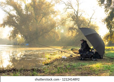 Fisherman on a sunny morning by the lake