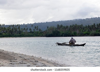 A Fisherman Paddles Out Of An Inlet In Samoa