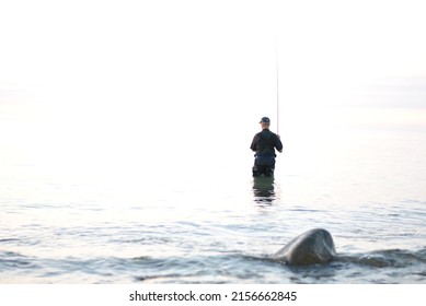 Fisherman In Silent Water By The Coast