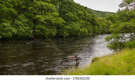 A fisherman spey casting for salmon using a fly rod on the River Orchy, Argyll, Scotland