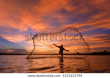 The fisherman trowing the nets on during sunrise,Thailand