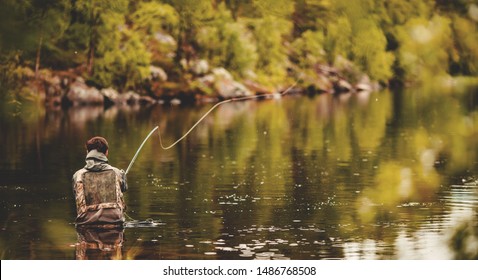 Fisherman Using Rod Fly Fishing In River Morning Sunrise Banner.