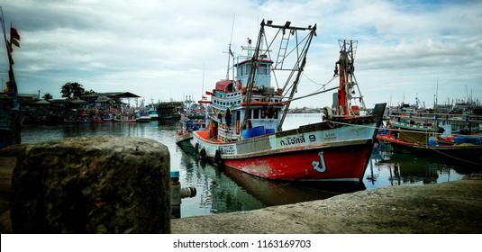 A Fisherman's Boat Come Back From The Sea, Thailand. Translation On The Boat's White Body 