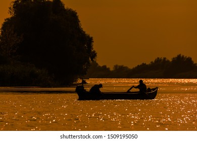 Fishermans boat at sunset in the Danube Delta, Romania - Powered by Shutterstock