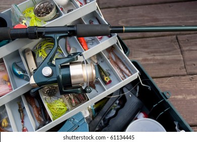 A fishermans rod reel and tackle box filled with lures and bait ready for the start of fishing season.