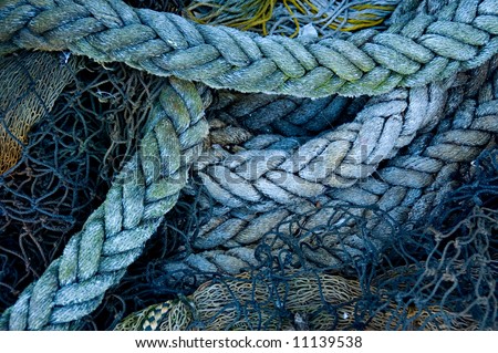 A fisherman's ropes and nets, piled on a wharf