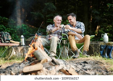 Fishermen drinking coffee beside bonfire  - Powered by Shutterstock