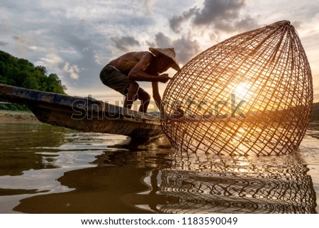 Fishermen fishing in the early morning golden light,fisherman fishing in Mekong River ,Thailand,Vietnam,myanmar,Laos