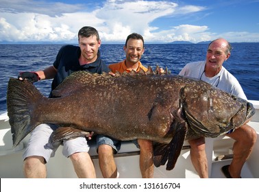 Fishermen Holding A Giant Grouper. Fishing Scene, Catch Of Fish. Indian Ocean Madagascar.