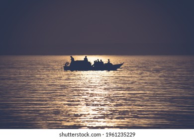 Fishermen on a boat in the sea at sunset - Shutterstock ID 1961235229