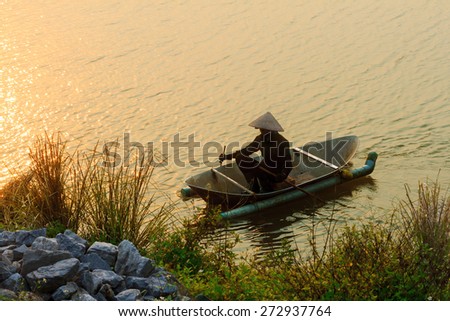 fishermen on a small boat in the sun sunset