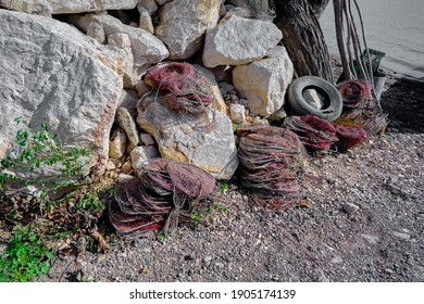 Fishermen stuff and fishnet for fishing standing on the rocks and stones in coast of the lake of uluabat waiting for drying under sunshine. - Shutterstock ID 1905174139