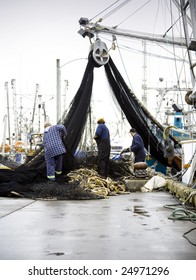Fishermen at work, preparing fish nets