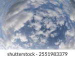 Fisheye photo of blue sky and white clouds ideal as a background for the concept of weather forecast or breathable air purity