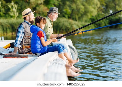 Fishing All Together. Men Of Three Generations Enjoying Morning While Fishing All Together