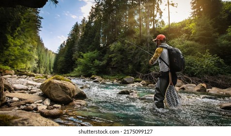 Fishing background. Fisherman catching trout on a river.	 - Powered by Shutterstock
