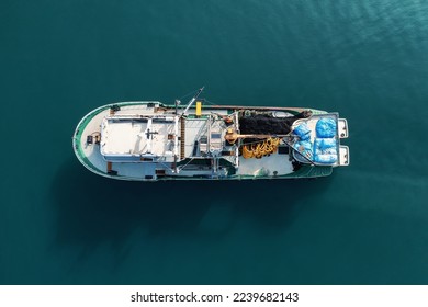 Fishing boat aerial view top from drone on sea surface. Fishing and seafood industry - Powered by Shutterstock