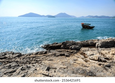 A Fishing Boat Anchored in a Calm Bay - Powered by Shutterstock