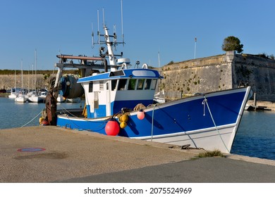 Fishing boat and the castle walls at Le Chateau d’Oleron, a  located on the island of Oleron in the Charente-Maritime department in southwestern France - Shutterstock ID 2075524969