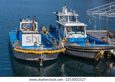 Image, Stock Photo Fishing boat moored in ocean water