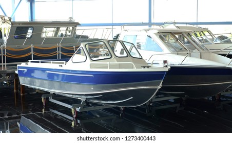 Fishing Boat. Motor Boat For Sale In The Store. Located On A Wheeled Cart