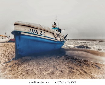 Fishing boat on the beach - Baltic Sea - moody HDR photography - breaking waves, cloudy sky