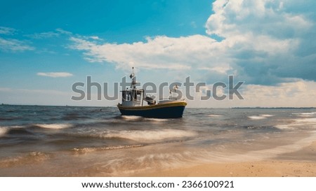 Fishing boat on the beach in Sopot, Poland. Magnificent long exposure calm Baltic Sea. Wallpaper defocused waves. Fishermans sea bay Vacation and holidays. travel attraction