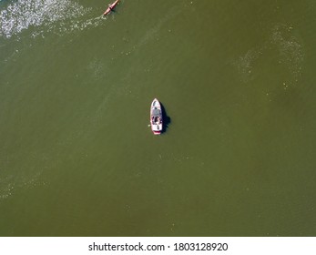 Fishing Boat On Green Water, Aerial Drone View. Algae Bloom In The River, Green Pattern On The Water.