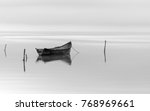 Fishing boat on lake in a clody day.Black and white photography