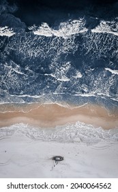 Fishing Boat On Snowy Beach And Winter Swimmer, Baltic Sea In Poland