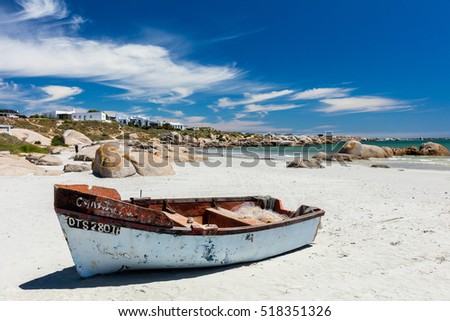 A fishing boat on the white sand of the beach at Paternoster on a bright sunny day