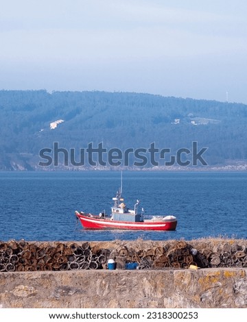 Fishing boat returning to port after fishing in the Galician Atlantic Ocean. Finisterre, Galicia, Spain.