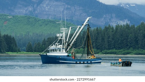 A Fishing boat sailing on the lake. Evergreen forest in the boreal zone. The turquoise blue sea. Various landscapes in summer.Alaska, USA., 2017 - Powered by Shutterstock