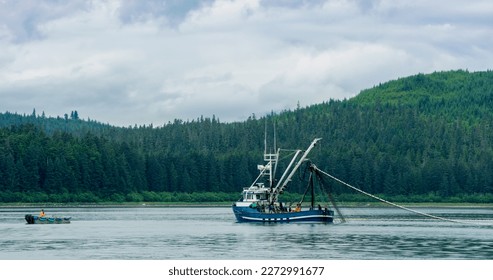 A Fishing boat sailing on the lake. Evergreen forest in the boreal zone. The turquoise blue sea. Various landscapes in summer.Alaska, USA., 2017