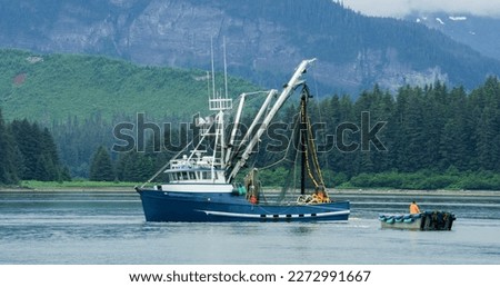 A Fishing boat sailing on the lake. Evergreen forest in the boreal zone. The turquoise blue sea. Various landscapes in summer.Alaska, USA., 2017