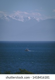 Fishing Boat In The Salish Sea Between Victoria, BC, Canada And Olympic Park WA, USA. Olympic Mountains In The Distance 