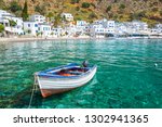 Fishing boat and the scenic village of Loutro in Crete, Greece