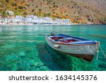 Fishing boat and the scenic village of Loutro in Crete, Greece
