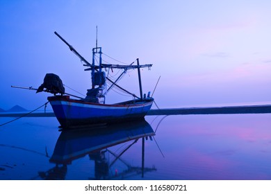 Fishing boat in the sea at twilight - Powered by Shutterstock