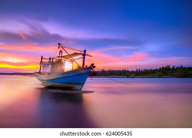 Fishing boat in tropical beach with beautiful sunset time. - Powered by Shutterstock