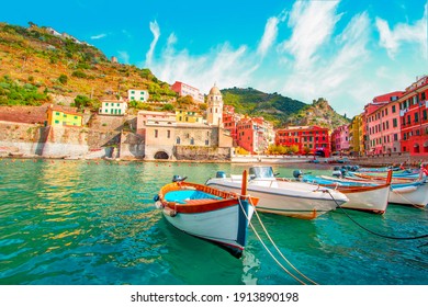 Fishing boat in Vernazza - Cinque Terre on the mountain near mediterranean sea in liguria - Italy. Sunny cloudy sky. Traditional italian architecture