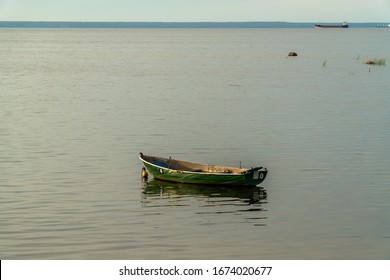 Fishing boats at anchor in the reeds in the shallow waters of the Gulf of Finland. - Powered by Shutterstock