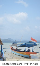 Fishing Boats Being Pulled Over On The Beach