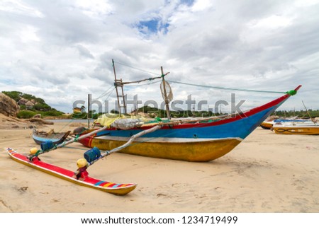  Fishing boats grounded on the sandbar between crocodile lagoon and Elephant Rock near Arugam Bay, Sri Lanka. Circa 2013