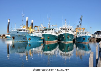 Fishing Boats in a Harbour and a Blue Sky - Powered by Shutterstock