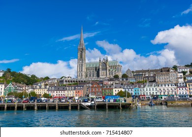 Fishing boats inside the port of Cobh. A city with colorful houses in Ireland. On the background the St Colman's Cathedral, one of the tallest building's in Ireland.