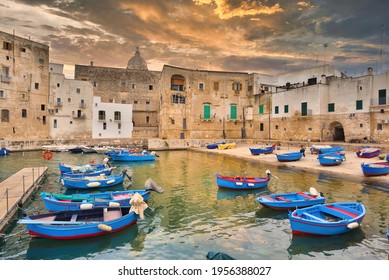Fishing boats in Monopoli city bay with cloudy sky background, southern Italy, Europe - Shutterstock ID 1956388027
