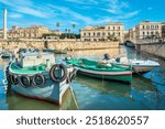 Fishing boats moored in harbour of Ortigia island. Syracuse, Sicily, Italy