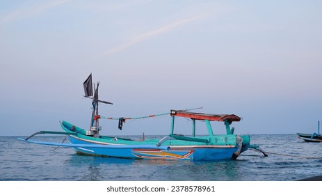 Fishing boats on the beach when the sun begins to set with a beautiful backdrop of sea and sand. - Powered by Shutterstock