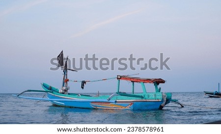 Fishing boats on the beach when the sun begins to set with a beautiful backdrop of sea and sand.